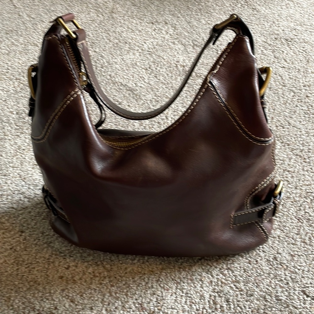 Michael Kors mocha brown hand bag with short strap. Buckle accents on sides